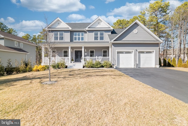 view of front facade featuring covered porch, driveway, a front lawn, and an attached garage