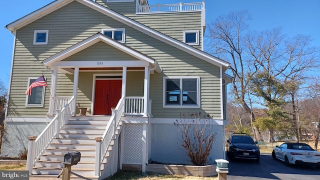 view of front facade featuring a porch and stairway