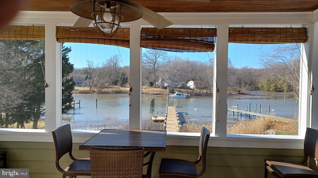 exterior space with a dock and a water view