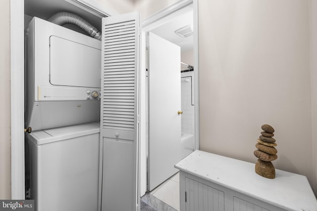 laundry area with laundry area and stacked washer and clothes dryer