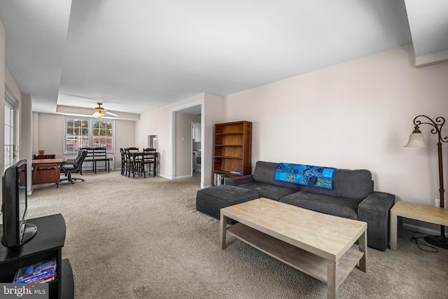 living area featuring a ceiling fan and carpet flooring