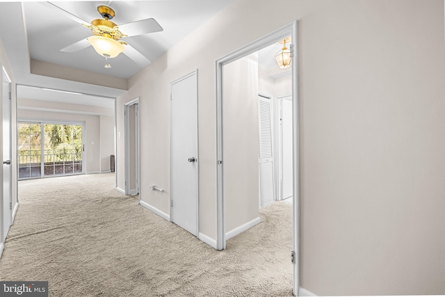 hall featuring baseboards and carpet