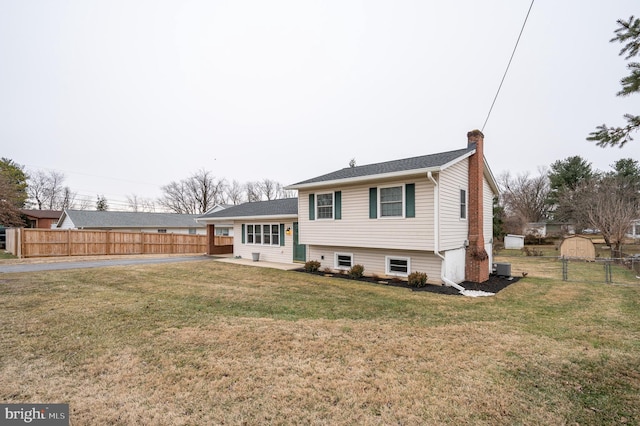 rear view of property featuring a yard