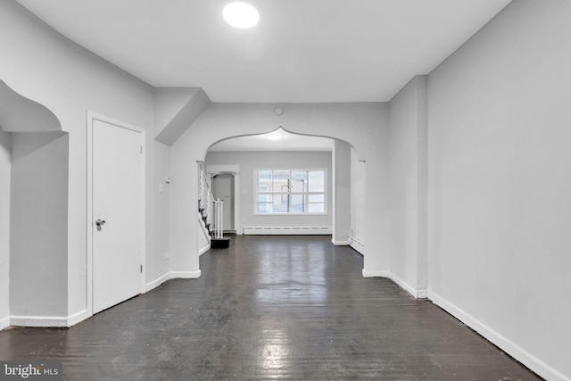 bonus room featuring dark hardwood / wood-style flooring and a baseboard radiator