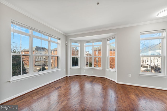 unfurnished room featuring dark wood-style floors, a healthy amount of sunlight, and baseboards