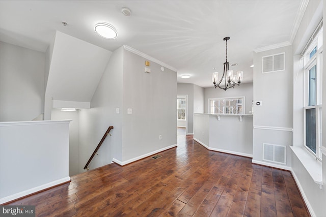 interior space with wood-type flooring, visible vents, and baseboards