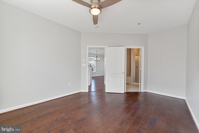 unfurnished room with wood-type flooring, baseboards, and ceiling fan with notable chandelier