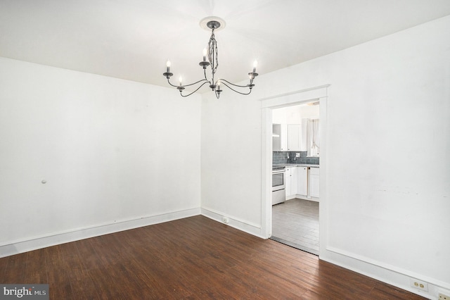 unfurnished dining area featuring dark wood-type flooring and a notable chandelier