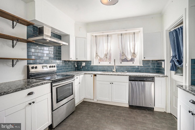 kitchen with appliances with stainless steel finishes, sink, and white cabinets