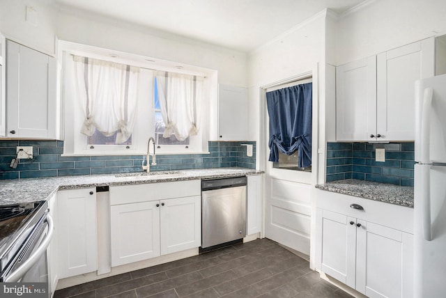 kitchen featuring appliances with stainless steel finishes, sink, and white cabinets