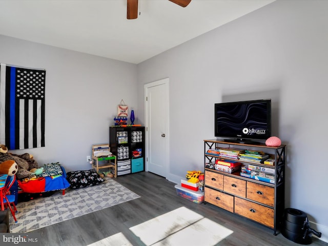 rec room with ceiling fan and dark hardwood / wood-style floors