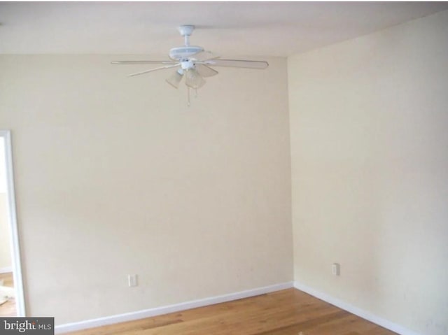 empty room with hardwood / wood-style floors and ceiling fan