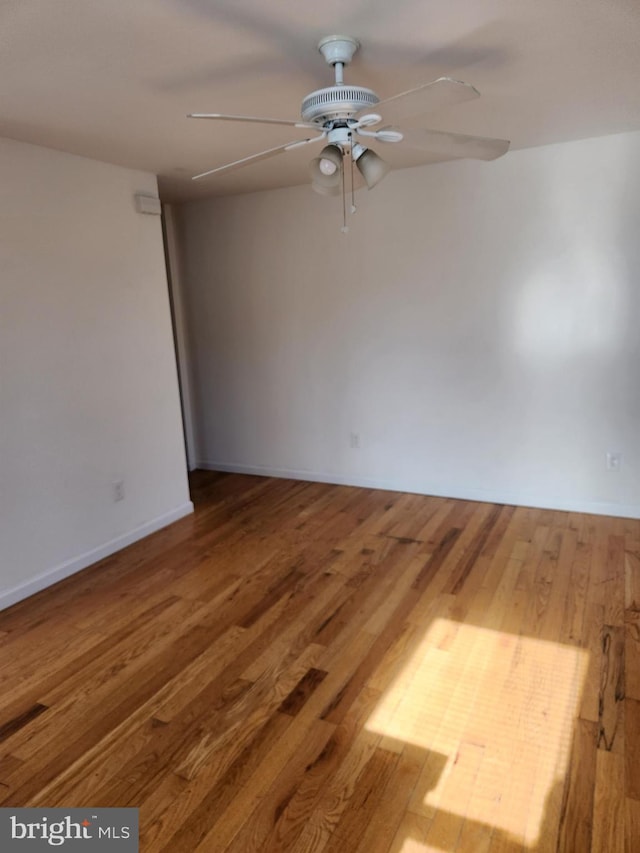 spare room with hardwood / wood-style flooring and ceiling fan