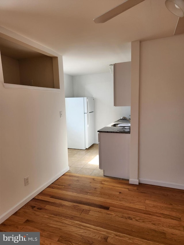 kitchen with white fridge and light hardwood / wood-style flooring