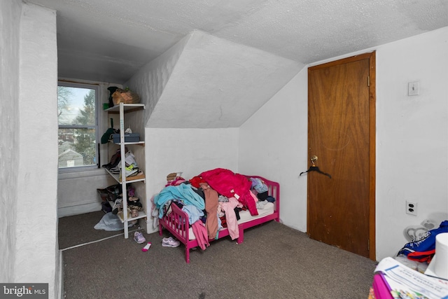 carpeted bedroom with lofted ceiling and a textured ceiling