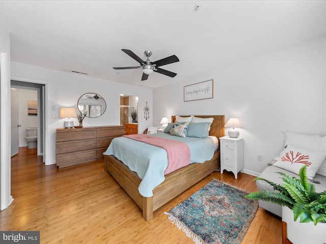 bedroom with visible vents, ceiling fan, ensuite bath, light wood-type flooring, and baseboards