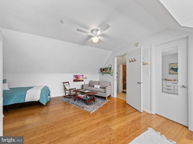 interior space with lofted ceiling, light wood-style floors, and ceiling fan