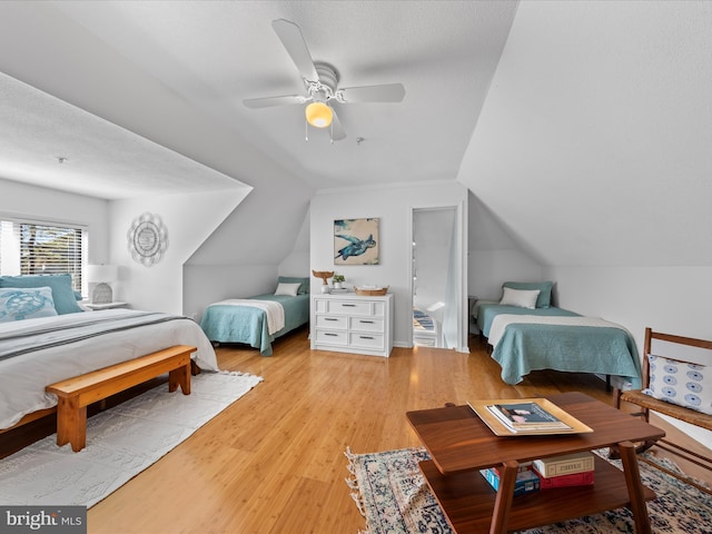 bedroom featuring lofted ceiling, a ceiling fan, and wood finished floors