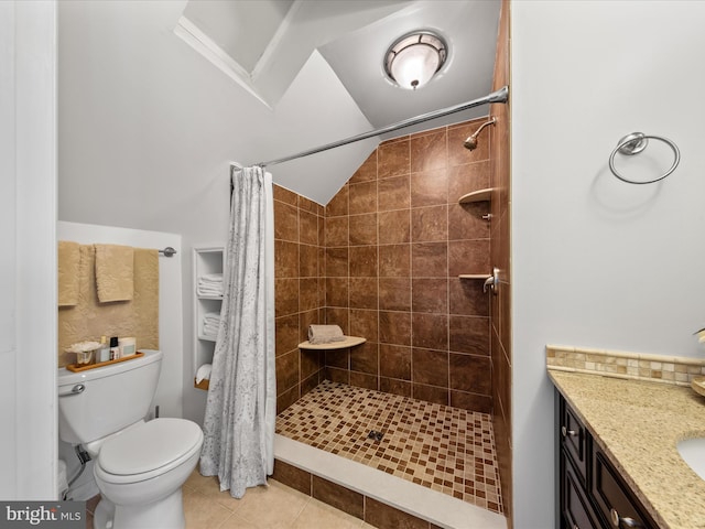 full bath with tiled shower, vanity, toilet, and tile patterned floors