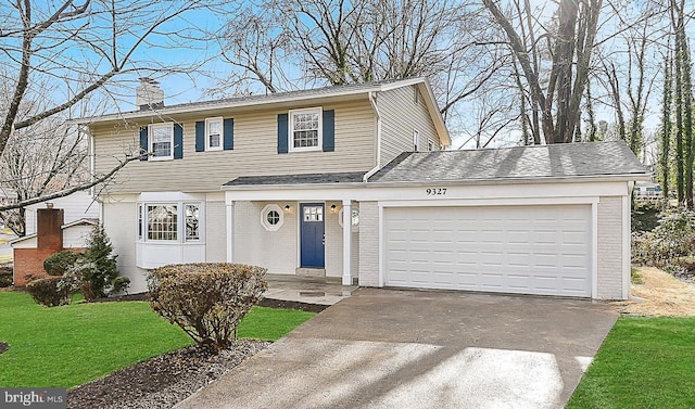 view of front facade featuring brick siding, concrete driveway, a front yard, a chimney, and a garage