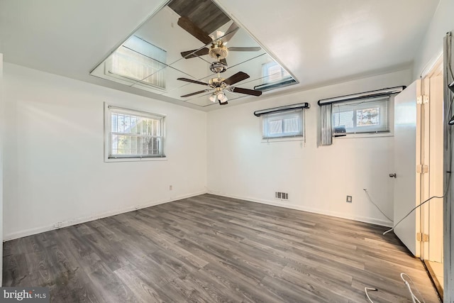 interior space featuring ceiling fan, plenty of natural light, and dark hardwood / wood-style floors