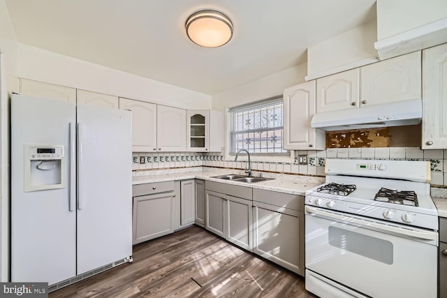 kitchen with tasteful backsplash, sink, white appliances, and white cabinets