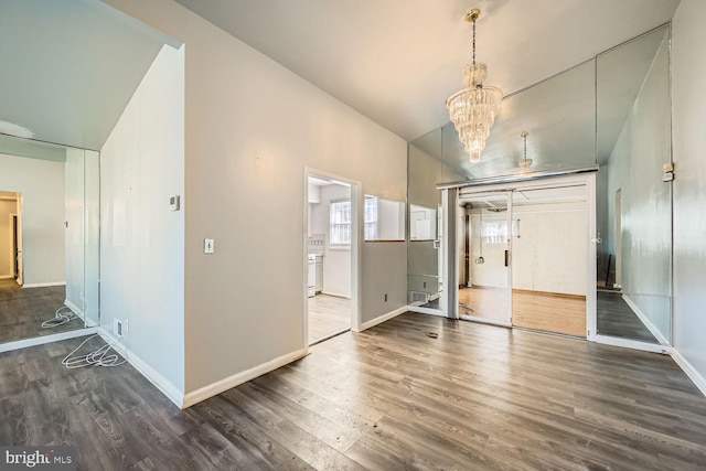 entrance foyer with a notable chandelier and dark hardwood / wood-style flooring