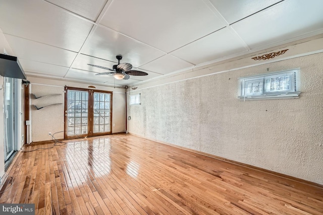 unfurnished room with french doors, ceiling fan, and hardwood / wood-style floors