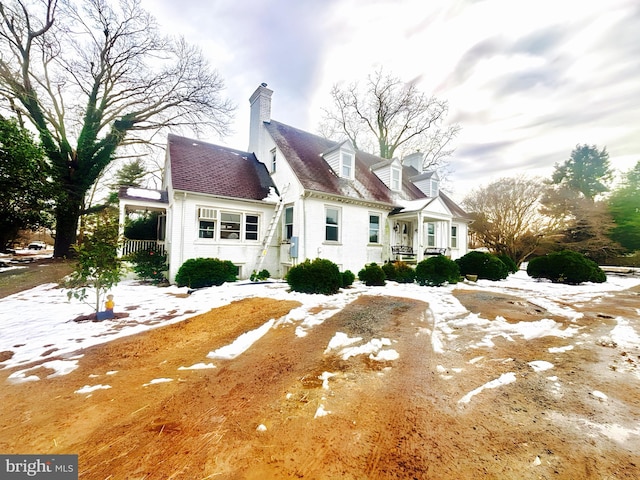 back of property with a porch