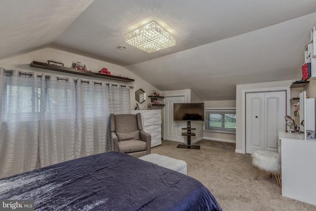 bedroom featuring baseboards, lofted ceiling, and carpet floors