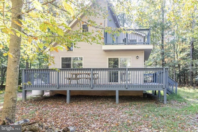 rear view of house featuring a deck