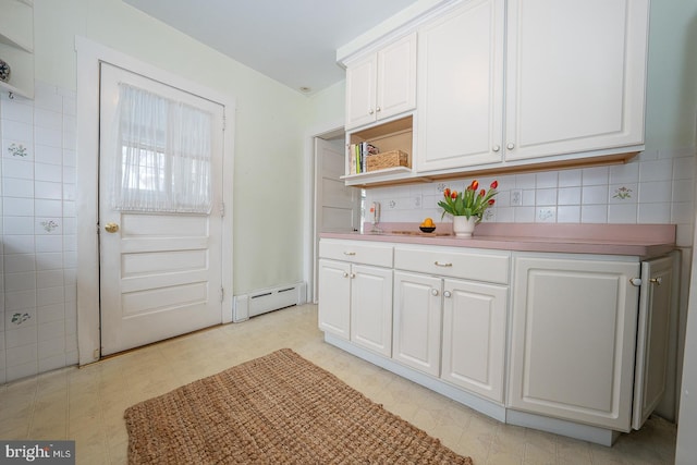 kitchen with tasteful backsplash, a baseboard heating unit, light floors, white cabinetry, and open shelves