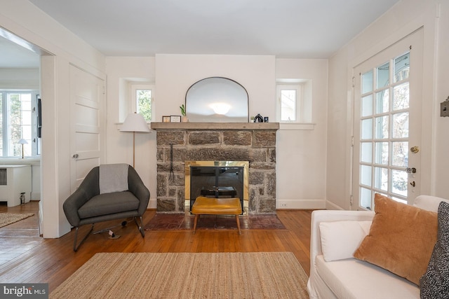 living area with a healthy amount of sunlight and wood finished floors