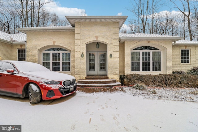 view of front of property featuring brick siding and french doors