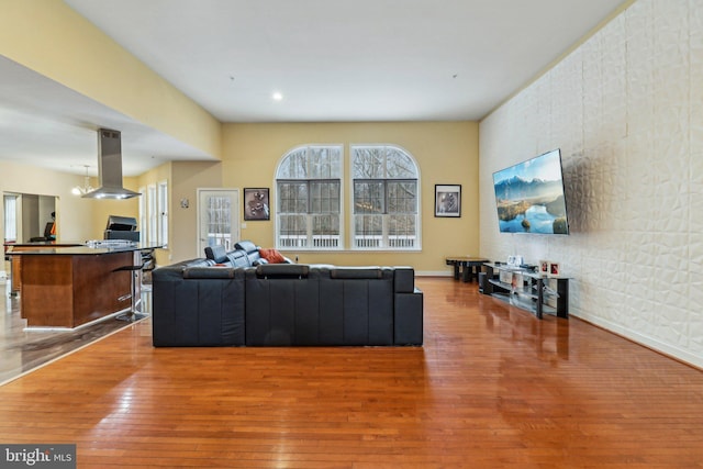 living room with recessed lighting, baseboards, and wood finished floors