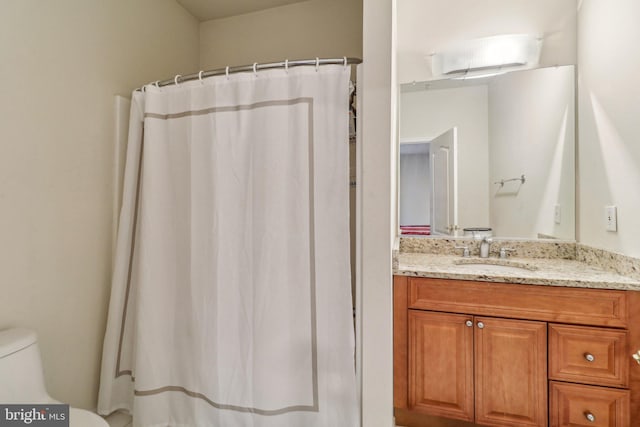 full bath featuring toilet and vanity