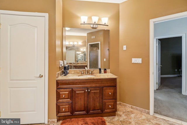 bathroom with vanity and baseboards