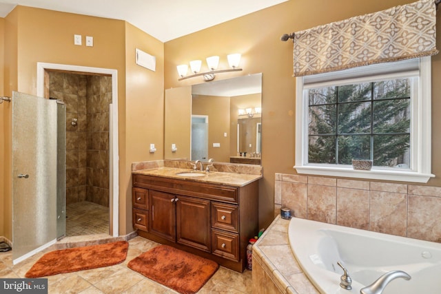 full bathroom with a garden tub, a shower stall, tile patterned flooring, and vanity