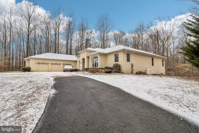 view of front of property featuring driveway and brick siding