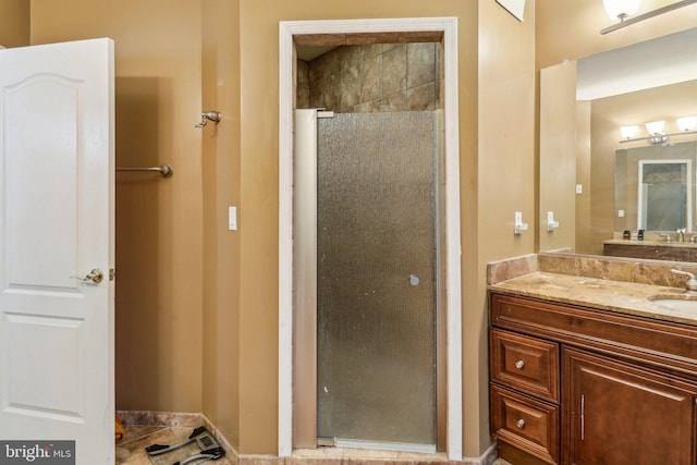 full bath featuring a shower stall and vanity