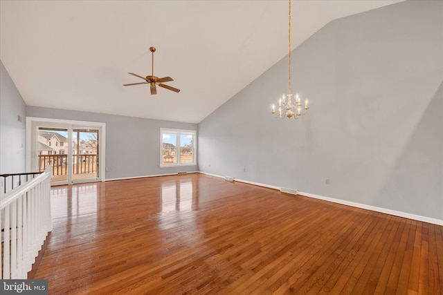 unfurnished living room with visible vents, wood finished floors, high vaulted ceiling, baseboards, and ceiling fan with notable chandelier