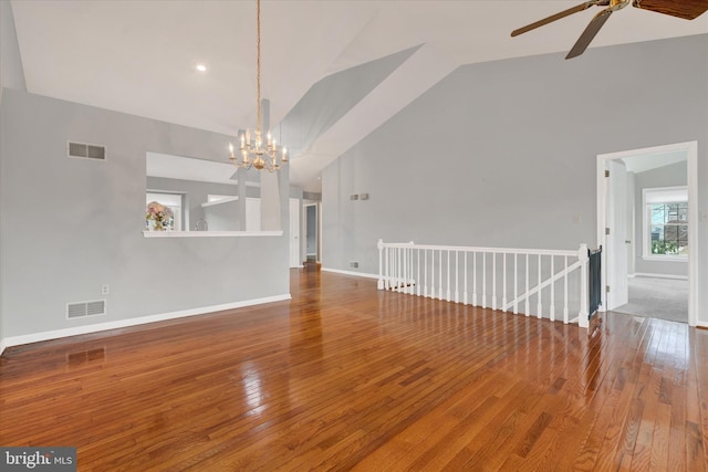 unfurnished living room featuring high vaulted ceiling, visible vents, baseboards, and wood finished floors