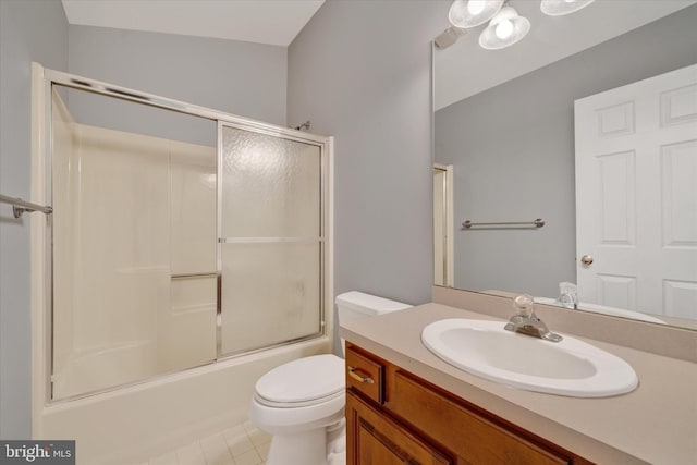 full bath with toilet, shower / bath combination with glass door, tile patterned floors, and vanity