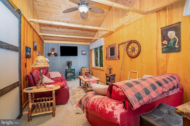 living room with wooden ceiling, a wood stove, carpet flooring, and wood walls