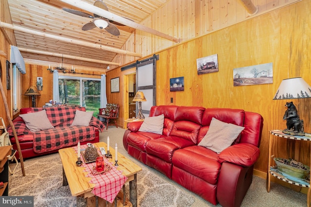 living room with a barn door, carpet floors, wooden ceiling, ceiling fan, and wooden walls