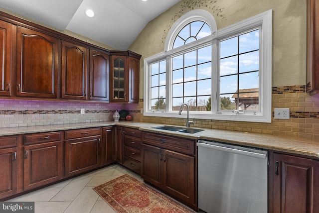 kitchen featuring sink, a wealth of natural light, vaulted ceiling, and stainless steel dishwasher