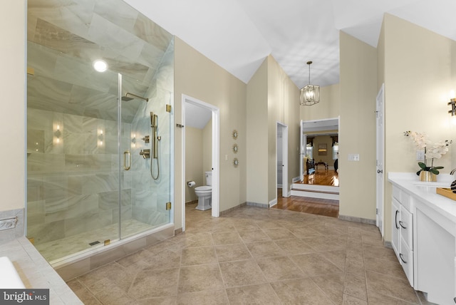 bathroom featuring vanity, a notable chandelier, toilet, a shower with door, and tile patterned floors