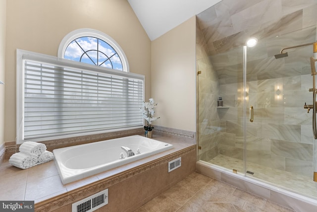 bathroom with lofted ceiling and independent shower and bath