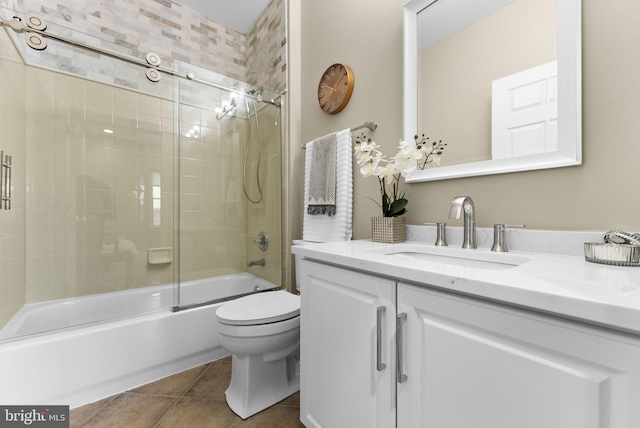 full bathroom with tile patterned floors, toilet, combined bath / shower with glass door, and vanity