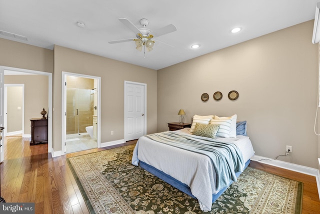 bedroom featuring ceiling fan, ensuite bathroom, and hardwood / wood-style floors